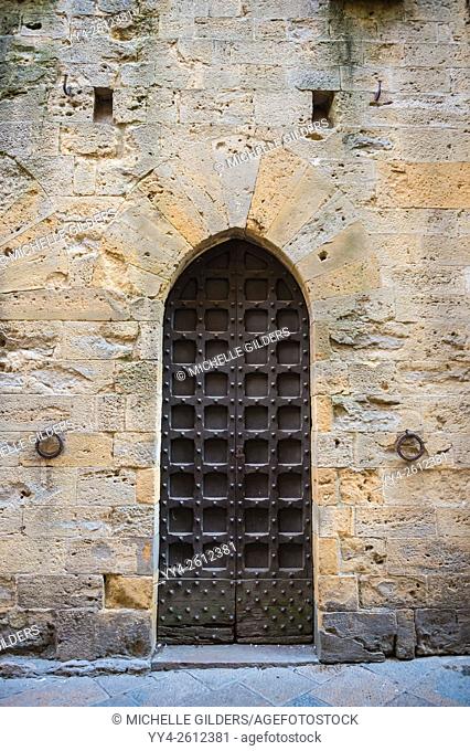 Doorway along cobbled street, , Volterra, Tuscany, Italy