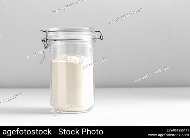 close up of jar with wheat flour on white table