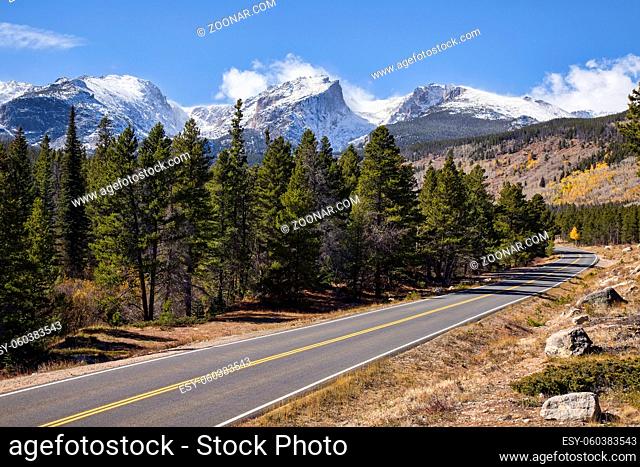 A scenic road winds through Rocky Mountain National Park in Colorado
