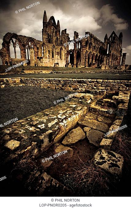 England, North Yorkshire, Whitby Abbey, Dark clouds over the ruins of the Benedictine abbey at Whitby