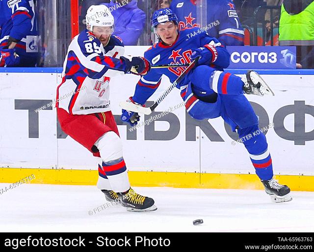 RUSSIA, ST PETERSBURG - DECEMBER 21, 2023: CSKA's Nikita Nesterov (L) and SKA's Vasily Glotov fight for the puck in a 2023/24 KHL Regular Season ice hockey...