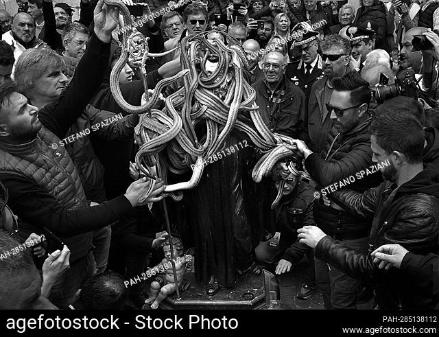 A statue of Saint Domenico surrounded by live snakes is held up by worshippers during an annual procession dedicated to the saint, in the streets of Cocullo