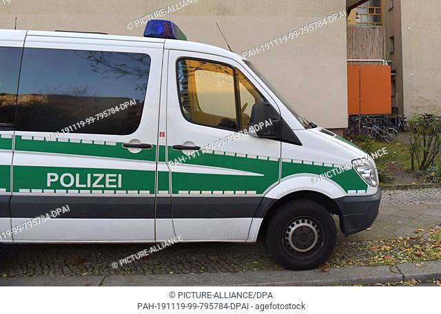 19 November 2019, Berlin: A police vehicle is standing in front of the house of a 26-year-old man who has been arrested on suspicion of terrorism
