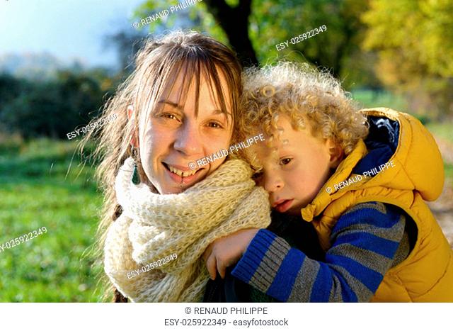 portrait of a little boy and his mom, an autumn day