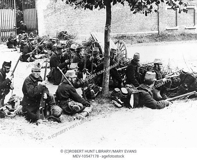 Scene during the Belgian army's retreat to Antwerp soon after the start of the First World War. Troops are seen here behind a barricade on a road outside...