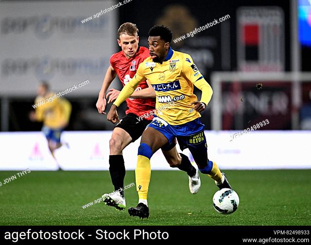 Rwdm's Klaus William and STVV's Joselpho Barnes fight for the ball during a soccer match between RWD Molenbeek and Sint-Truidense VV