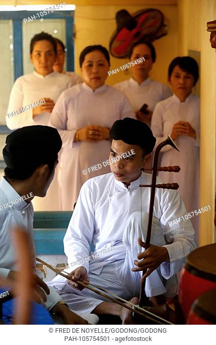 Cao Dai temple. Cao Dai worshipper play music at service. Phu Quoc. Vietnam. | usage worldwide. - Duong Dong/Phu Quoc/Vietnam