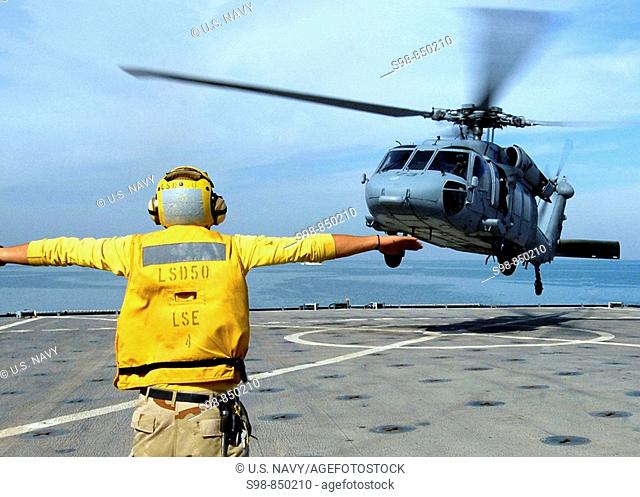 PERSIAN GULF (Nov. 20, 2008) Boatswain's Mate 2nd Class Cody Rufener directs an SH-60B from Helicopter Sea Combat Squadron (HSC) 26 aboard the amphibious dock...