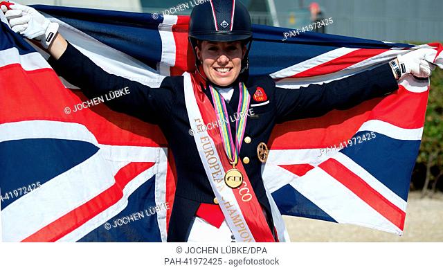 British rider Charlotte Dujardin cheers with a Union Jack after winning the Grand Prix Special Dressage Competition of the FEI European Championships in jumping...