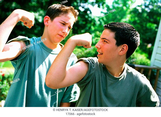 Boys flexing muscles