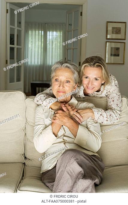 Mother and daughter spending time in living room