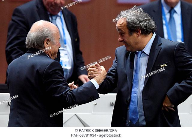 FIFA President Joseph Blatter (L) and UEFA President Michel Platini shake hands during the 65th FIFA Congress with the president's election at the Hallenstadion...