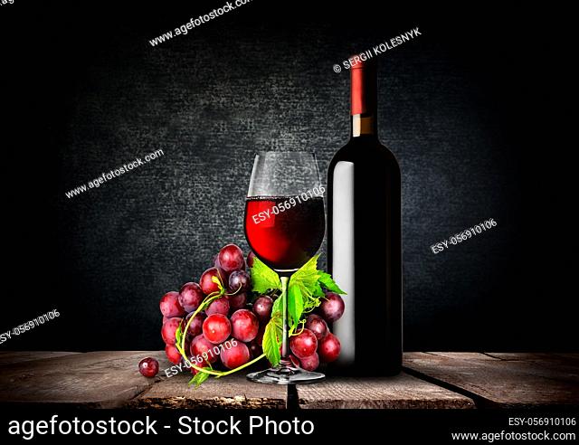 Bottle and glass of red wine and grapes