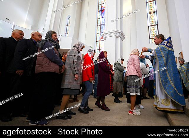 RUSSIA, LUGANSK - OCTOBER 14, 2023: A woman venerates Our Lady of Vladimir during a service at the Church of Our Lady of Tenderness to mark the Christian feast...