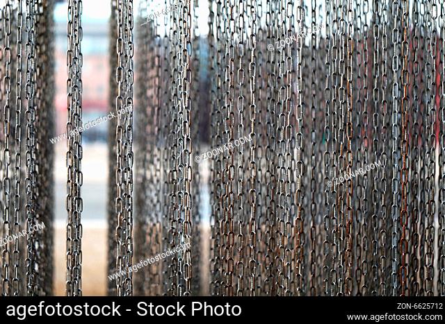 Texture of hanging chains on the background of the river