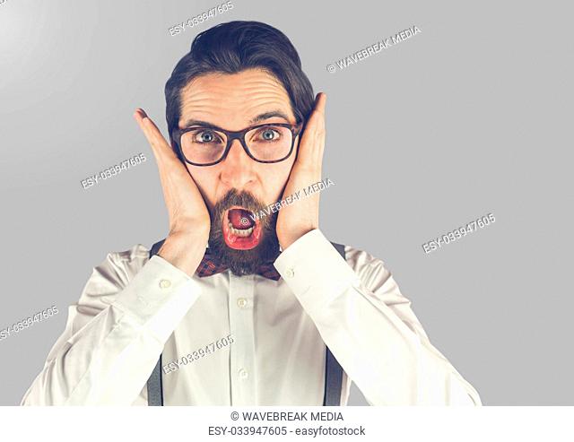 Portrait of shocked surprised Man with grey background
