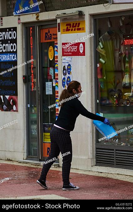 Worker clean with water her shop on April 22, 2020 in Madrid, Spain. Starting last week, some businesses deemed non-essential have been allowed to resume...