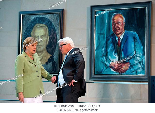 FILE - An archive picture dated 11 June 2014 shows German Chancellor Angela Merkel and German Minister for Foreign Affairs Frank-Walter Steinmeier talking in...
