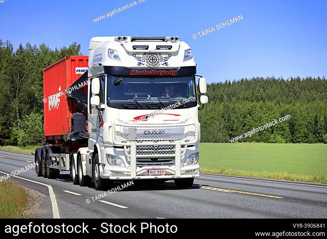 Beautifully customized white DAF XF truck Marko Pohja Oy hauls red container on Highway 2 on a sunny day of summer. Jokioinen, Finland. June 15, 2020