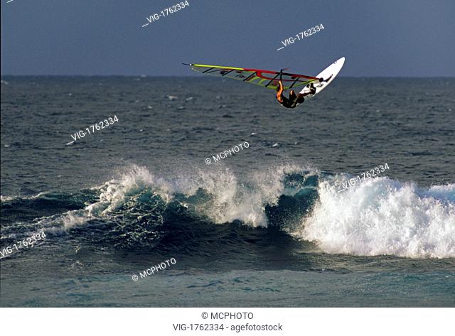 A WINDSURFER catches major air on the world class waves at HOOKIPA BEACH PARK - MAUI, HAWAII - 31/07/2009