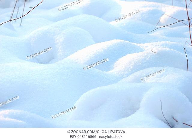 Field of shiny white snow. Real snow surface for backgrounds. Shallow depth of field