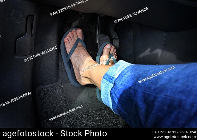 PRODUCTION - 15 June 2022, Bavaria, Buching: ILLUSTRATION - A woman operates the pedals of a car wearing flip flops. Events will be held to draw attention to...