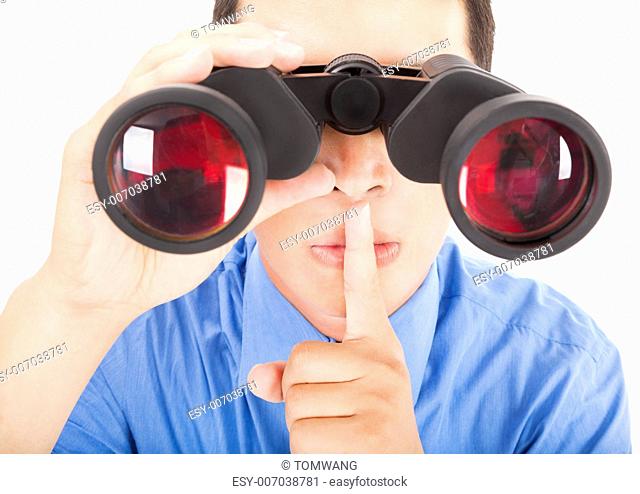 man looks through binoculars with silent gesture