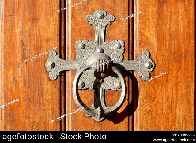 Old door knocker on brown wooden door, Germany, Europe