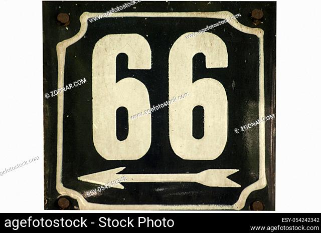 Weathered grunge square metal enameled plate of number of street address with number 65 closeup isolated on white background