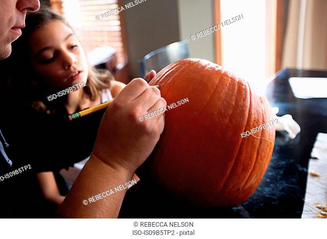 Father and daughter pumpkin carving