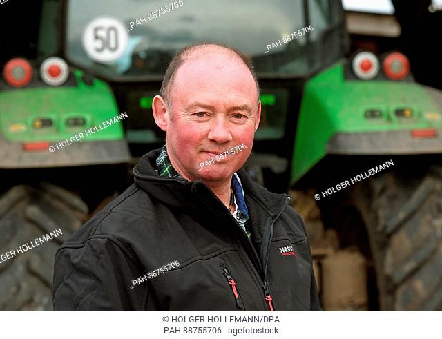 Farmer Andreas Strahlmann stands in front of a tractor at his farm in Wettmar, Germany, 28 February 2017. 60 horses live in the horse boxes he rents out to...