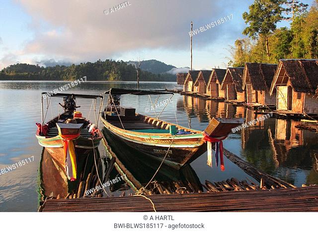 longtail boats and huts at Cheow Lan Lake in morning light, Thailand, Phuket, Khao Sok NP