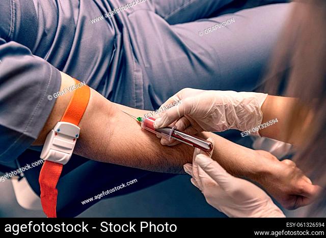 Laboratory technician taking blood for blood chemistry diagnosis