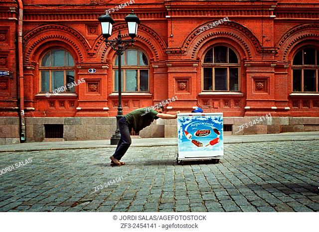 Man pushing a fridge in the red square