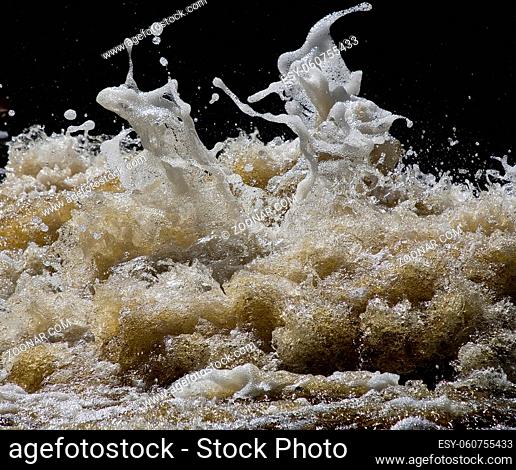 foaming and splashing yellow waves of a river