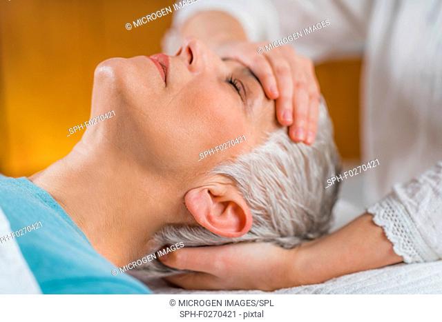 Marma therapy. Senior woman lying on massage table and enjoying Ayurveda facial treatment