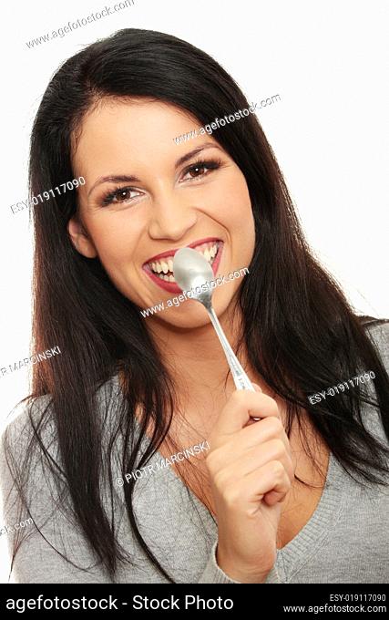 Woman with spoon in her mouth