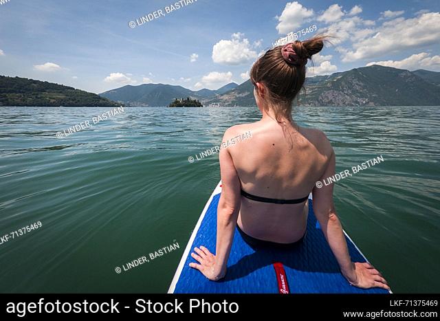 Woman on SUP board in the water on Lake Iseo, Italy