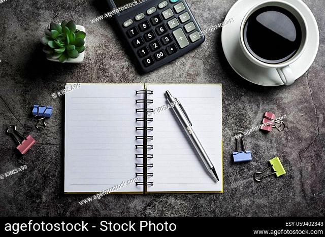 Concrete table with coffee with office accessories.Top view of Coffee cup on concrete background with copy space