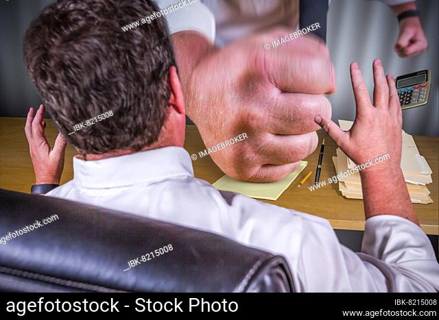 Big boss fist slamming down on male worker desk, work stress pressure series