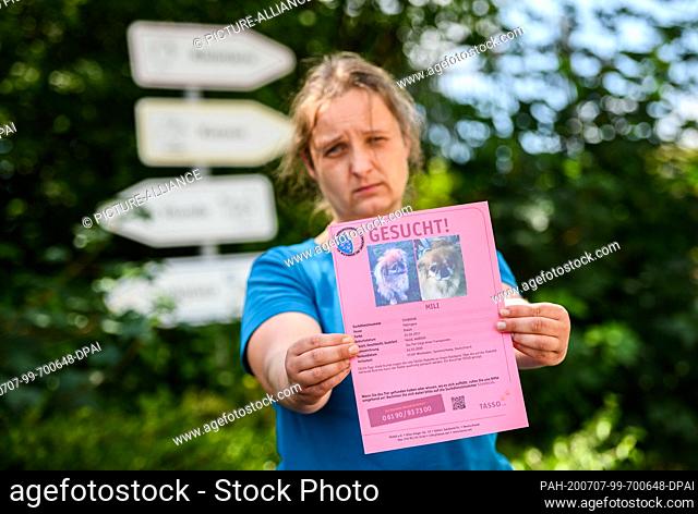 22 June 2020, Hessen, Wiesbaden: Nadine Bernardy, head of the animal shelter Wiesbaden, holds a profile of Pekinese ""Mili"", who was stolen from the shelter