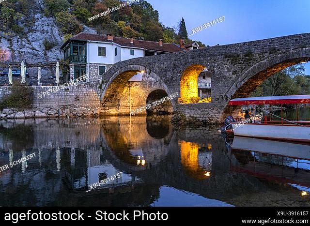 The old bridge Stari Most over Rijeka Crnojevica river in Rijeka Crnojevica at dusk, Montenegro, Europe