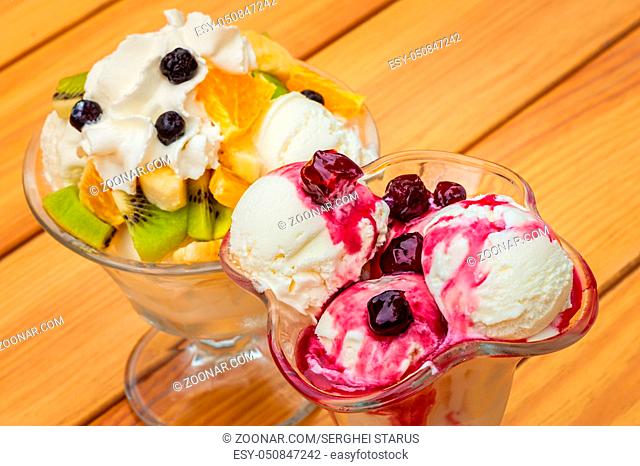 Orange, banana, kiwi and cherry syrup fruit salad with icecream