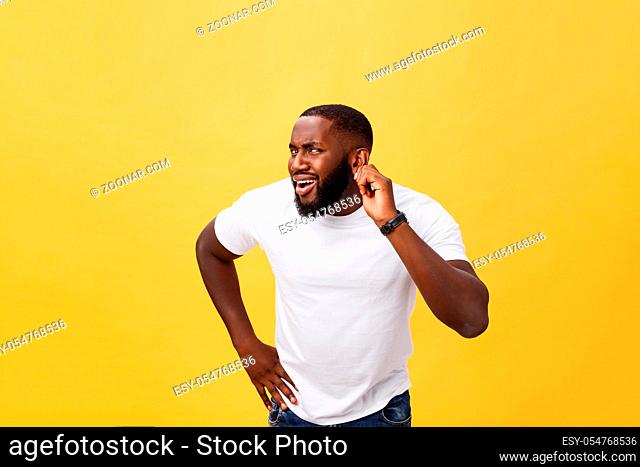Headshot of goofy surprised bug-eyed young dark-skinned man student wearing casual white t-shirt staring at camera with shocked look