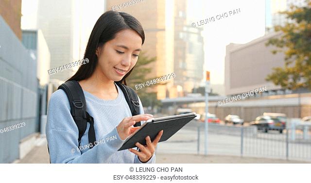 Asian woman using tablet computer at outdoor