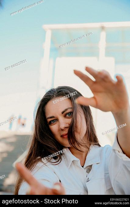 Close-up shot of happy young woman, wears white clothing. Lifestyle concept. High quality photo
