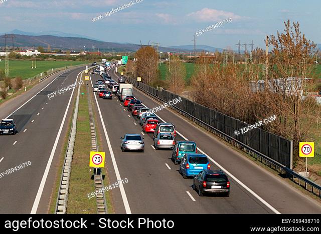 Sofia, Bulgaria - April 24, 2020: A queue of stopped cars leaving Sofia. Police control Sofia exit, Bulgaria's capital is quarantined by COVID -19 virus