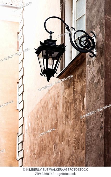 Lamp post on wall exterior in Rynek Starego Miasta, the historic Old Town that was extensively rebuilt in 1953 after WW2, Warsaw, Poland, Europe