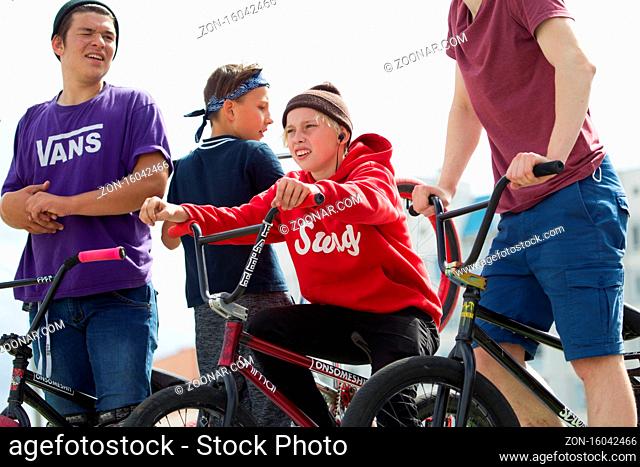 Teens on bicycles;