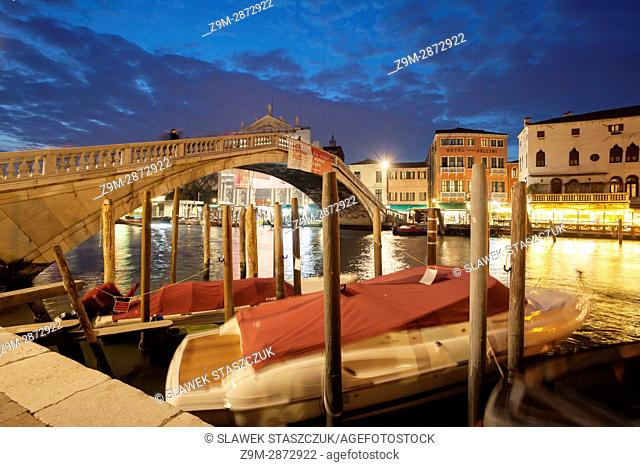 Night falls at Scalzi bridge across Grand Canal in Venice, Italy